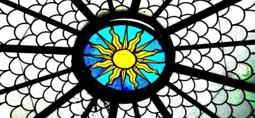 stained glass skylight with sun in center.