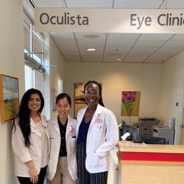 3 female students smiling at eye clinic