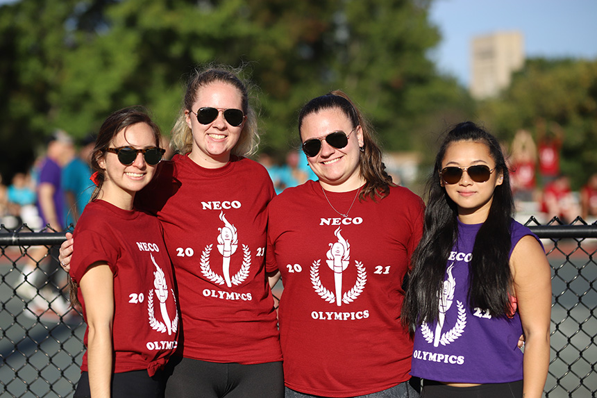 Four students with arms around each other, in tshirts for the NECO Olympics