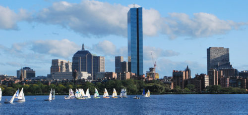View of Boston over the Charles River with sailboats.