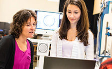 Faculty talking with student in research lab.