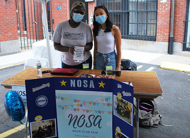 Two members of NOSA club share information at the NECO Club Fair.