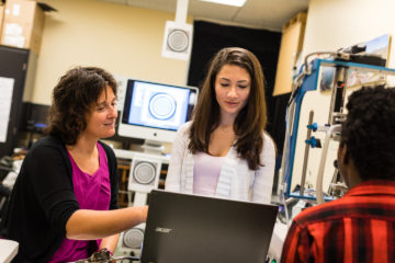 faculty and student look over screen in lab