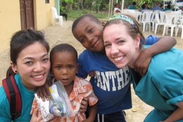 Two students and two children meet during a VOSH trip to the DR.